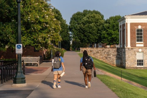 Two students walking by the Amphitheater