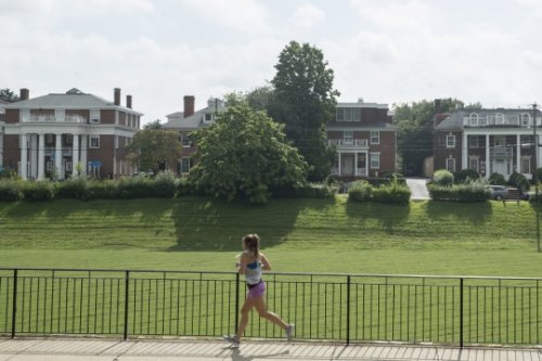 Woman running by Greek houses