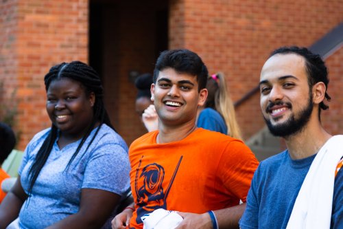 Three students smiling outside