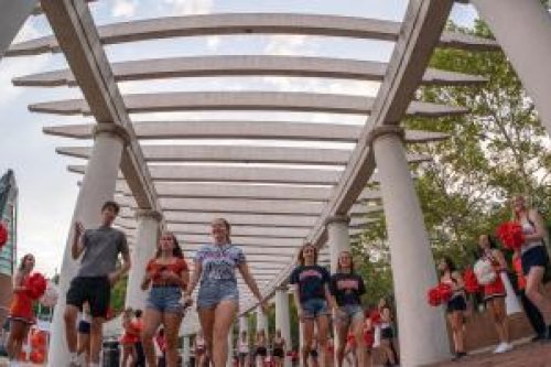 Students walking through the columns