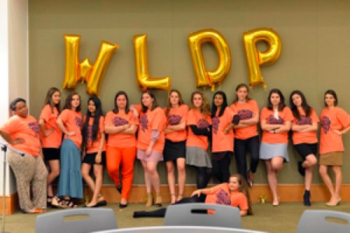 Group photo in front of balloon letters WLDP
