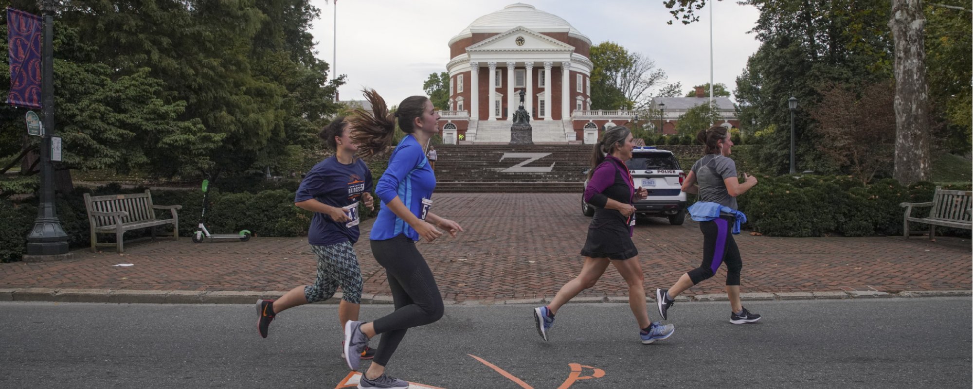 Students running in front of the Rotunda