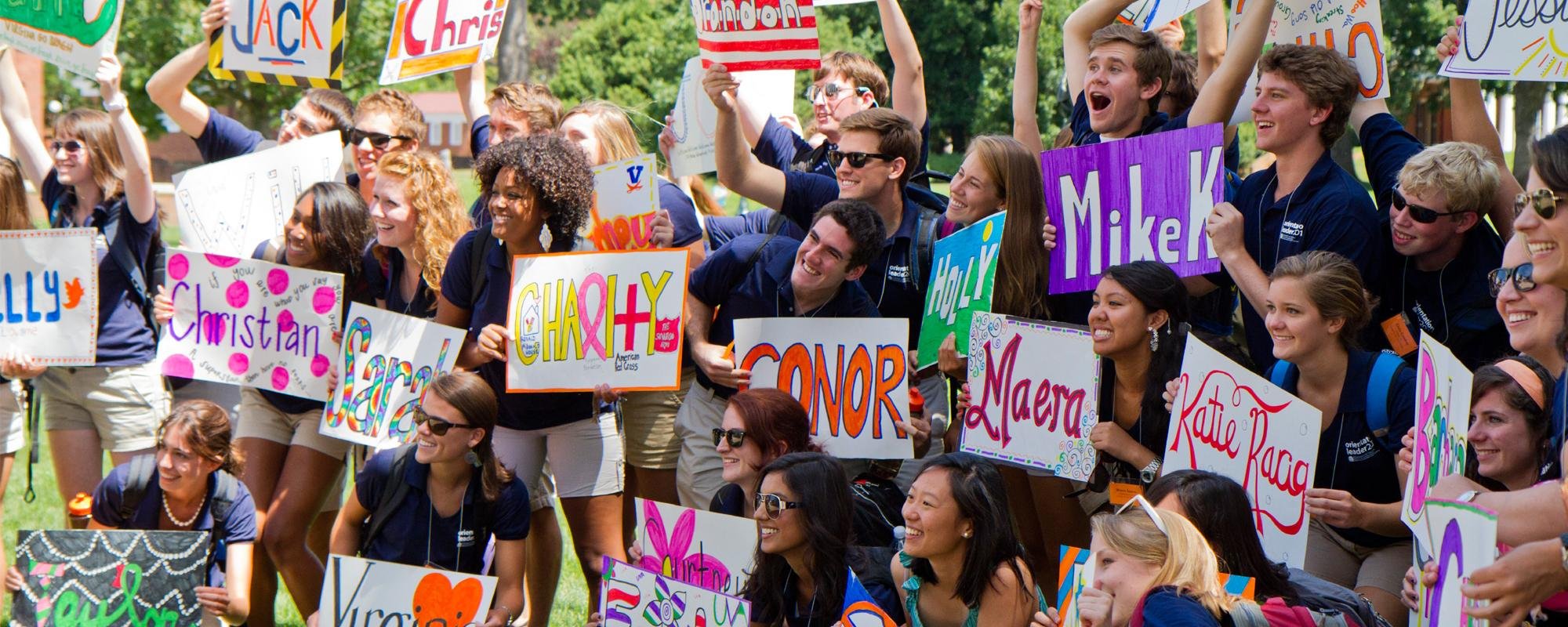 Group of Orientation Leaders holding signs on the Lawn