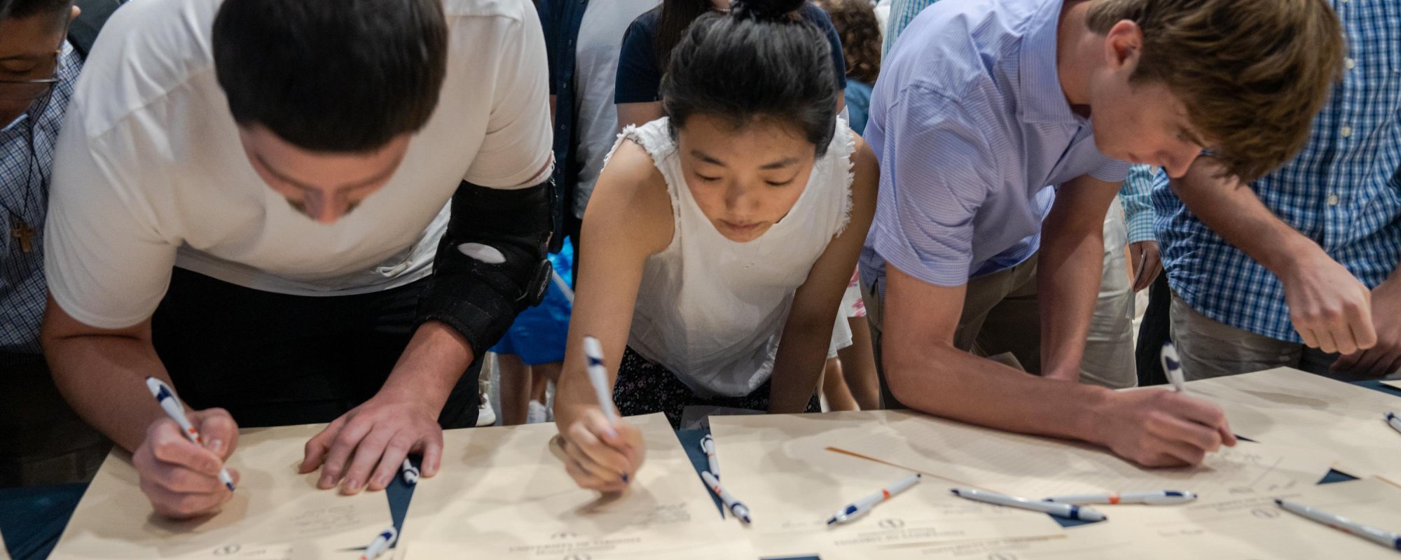 Three students signing the Honor Code