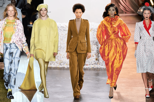 Four models walking down runway